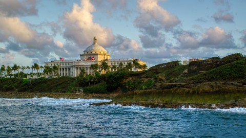 AX104_046.0000042F - Aerial stock photo of Oceanfront San Juan Capitol Building, Old San Juan Puerto Rico, sunset