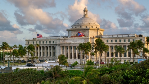 AX104_047.0000000F - Aerial stock photo of The San Juan Capitol Building, Old San Juan, Puerto Rico, sunset