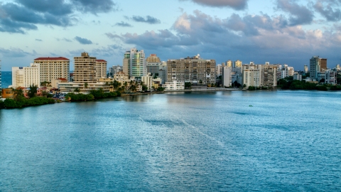 AX104_060.0000309F - Aerial stock photo of Hotels beside Condado Lagoon, San Juan, Puerto Rico sunset