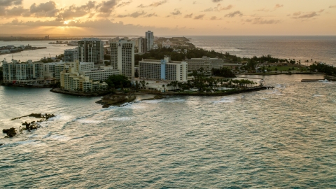 The oceanfront Caribe Hilton Hotel and Normandie Hotel, San Juan, Puerto Rico, sunset Aerial Stock Photos | AX104_072.0000000F