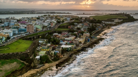 Oceanfront Caribbean homes, Old San Juan, Puerto Rico, sunset Aerial Stock Photos | AX104_078.0000146F