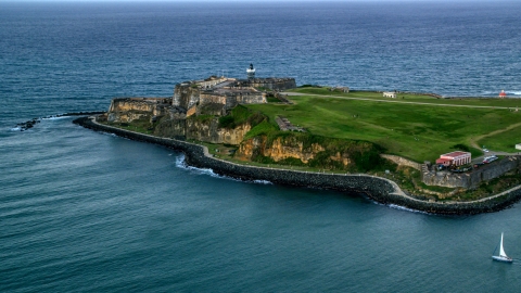 Fort San Felipe del Morro surrounded by Caribbean blue ocean waters, Old San Juan, twilight Aerial Stock Photos | AX104_086.0000000F