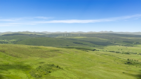 Hilltop windmills and farm fields in Denny, Scotland Aerial Stock Photos | AX109_005.0000000F