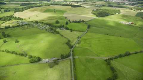 Farms and green farm fields in Stirling, Scotland Aerial Stock Photos | AX109_010.0000000F