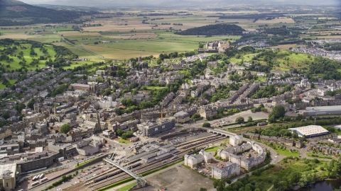 AX109_028.0000013F - Aerial stock photo of Historic Stirling Castle seen from apartment buildings, Scotland