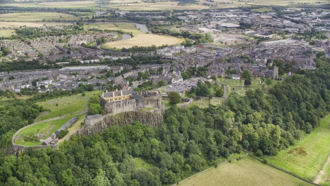 Stirling Castle on a tree covered hill, Scotland Aerial Stock Photos | AX109_037.0000000F