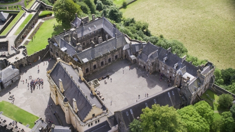 The historic Stirling Castle and grounds with tourists, Scotland Aerial Stock Photos | AX109_042.0000106F