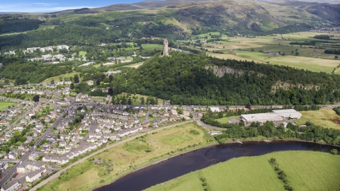 This historic Wallace Monument surrounded by trees, Stirling, Scotland Aerial Stock Photos | AX109_046.0000133F