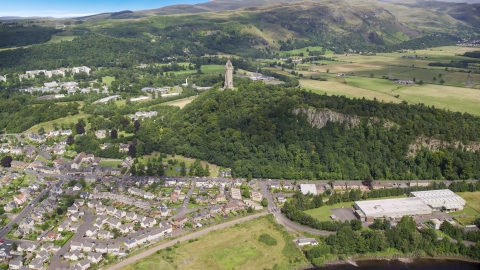 The historic Wallace Monument on a hill with trees, Stirling, Scotland Aerial Stock Photos | AX109_047.0000064F