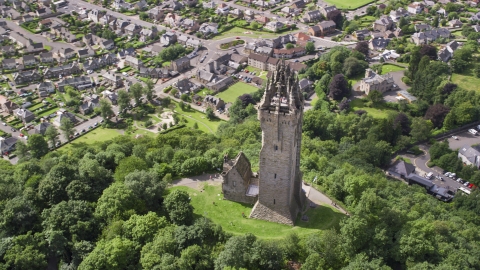 The historic Wallace Monument with tourists on top of the tower, Stirling, Scotland Aerial Stock Photos | AX109_051.0000000F