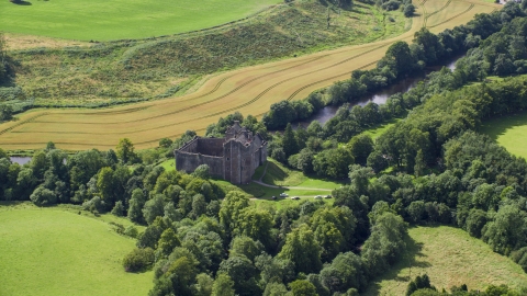 Historic Doune Castle and trees in Scotland Aerial Stock Photos | AX109_066.0000000F