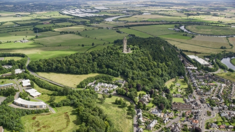 AX109_099.0000000F - Aerial stock photo of Historic Wallace Monument atop Abbey Craig hill, Stirling, Scotland