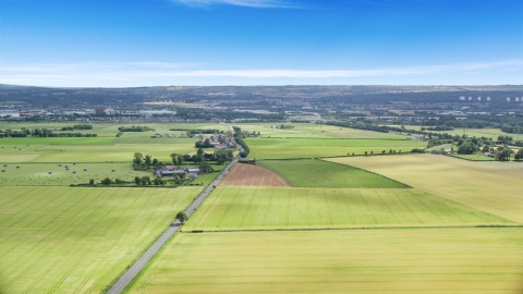 AX109_116.0000115F - Aerial stock photo of Farms and farm fields by A905 highway, Falkirk, Scotland