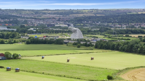 AX109_120.0000000F - Aerial stock photo of The Kelpies sculptures from seen from fields, Falkirk, Scotland