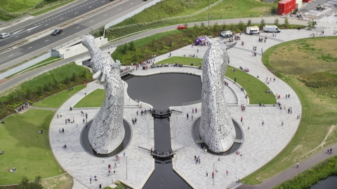 The Kelpies sculptures with tourists in Falkirk, Scotland Aerial Stock Photos | AX109_126.0000000F