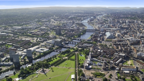 AX110_163.0000000F - Aerial stock photo of A wide view of River Clyde and bridges near city buildings in Glasgow, Scotland