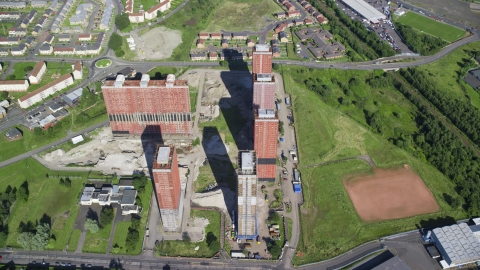 A group of tall apartment buildings in Glasgow, Scotland Aerial Stock Photos | AX110_216.0000159F