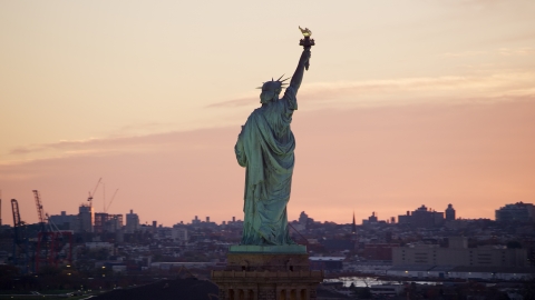 Behind the Statue of Liberty at sunrise, New York Aerial Stock Photos | AX118_042.0000234F