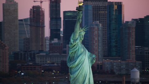 AX118_046.0000299F - Aerial stock photo of The Statue of Liberty at sunrise, New York