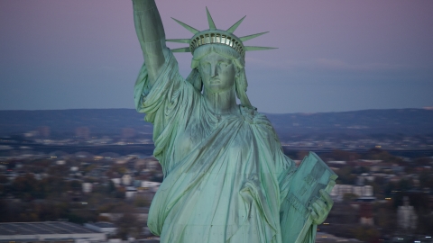 Statue of Liberty at sunrise, purple sky overhead, New York Aerial Stock Photos | AX118_059.0000153F