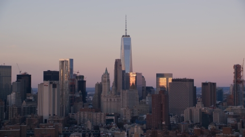 AX118_070.0000078F - Aerial stock photo of Freedom Tower and skyscrapers at sunrise in Lower Manhattan, New York City