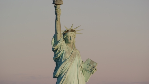 The front of the Statue of Liberty at sunrise in New York Aerial Stock Photos | AX118_107.0000082F