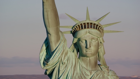 AX118_116.0000231F - Aerial stock photo of A close-up of the Statue of Liberty at sunrise in New York