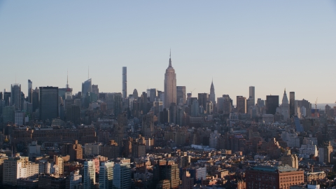 AX118_157.0000074F - Aerial stock photo of The Empire State Buildings and Midtown skyscrapers at sunrise in New York City