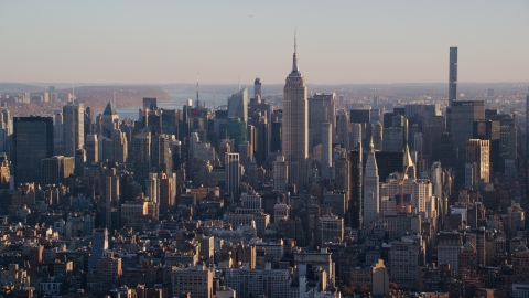 AX118_169.0000092F - Aerial stock photo of Empire State Building and Midtown Manhattan buildings at sunrise in New York City