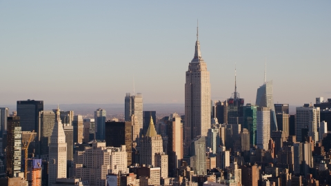 AX118_176.0000000F - Aerial stock photo of Empire State Building and Midtown high-rises at sunrise in New York City