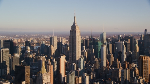 AX118_178.0000099F - Aerial stock photo of The Empire State Building and surrounding Midtown high-rises at sunrise in New York City