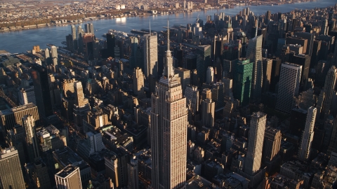 AX118_181.0000135F - Aerial stock photo of Empire State Building at sunrise in Midtown Manhattan, New York City