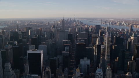 AX118_197.0000231F - Aerial stock photo of Midtown Manhattan skyscrapers at sunrise in New York City