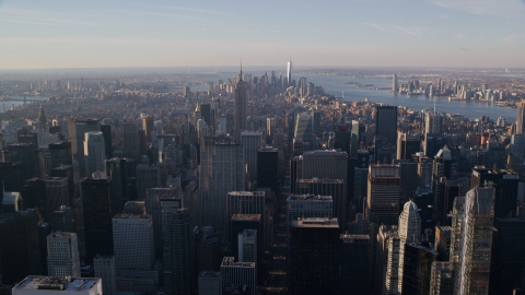 AX118_198.0000141F - Aerial stock photo of Midtown and Downtown Manhattan skyscrapers at sunrise in New York City