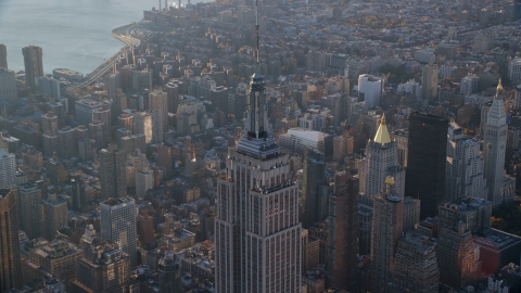 AX118_204.0000082F - Aerial stock photo of The spire on top of the Empire State Building at sunrise in Midtown Manhattan, New York City