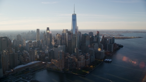 AX118_213.0000092F - Aerial stock photo of World Trade Center buildings at sunrise in Lower Manhattan, New York City