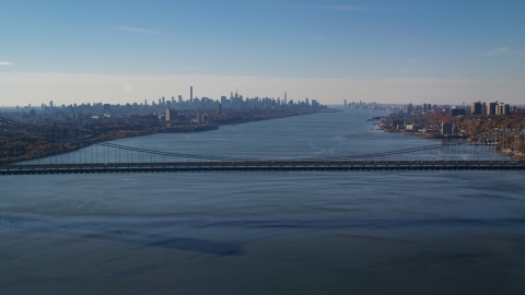 AX119_047.0000192F - Aerial stock photo of George Washington Bridge, Hudson River, and the Midtown skyline in Autumn, New York City