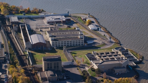 AX119_118.0000080F - Aerial stock photo of Buildings at Sing Sing Correctional Facility in Autumn, Ossining, New York