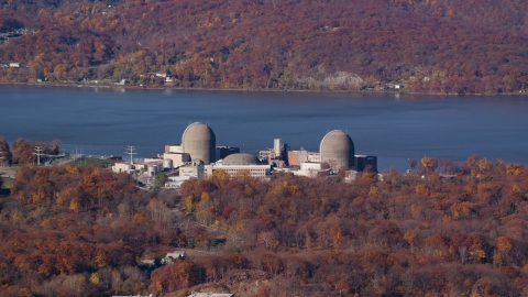 AX119_143.0000075F - Aerial stock photo of Indian Point Energy Center nuclear plant in Autumn, Buchanan, New York