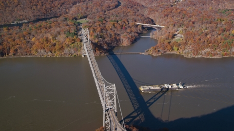 AX119_153.0000270F - Aerial stock photo of Oil tanker near Bear Mountain Bridge in Autumn, Westchester County, New York