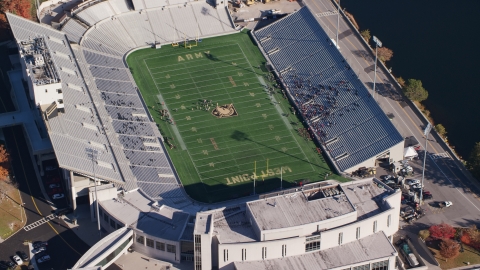 AX119_178.0000078F - Aerial stock photo of Michie Stadium in Autumn, West Point Military Academy, New York