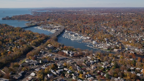 AX119_232.0000028F - Aerial stock photo of Marinas on the Mianus River by homes in Autumn, Greenwich, Connecticut