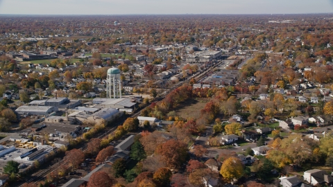 AX119_255.0000120F - Aerial stock photo of Industrial buildings and train tracks in Autumn, Farmingdale, New York