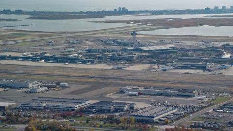 AX120_049.0000064F - Aerial stock photo of Control tower and terminals of John F. Kennedy International Airport in Autumn, Queens, New York City