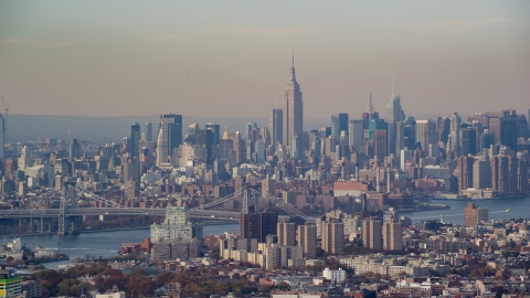 AX120_083.0000197F - Aerial stock photo of Midtown Manhattan skyline across the East River, seen from Brooklyn in Autumn, New York City