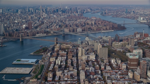 AX120_091.0000087F - Aerial stock photo of The Brooklyn and Manhattan Bridges spanning the East River in Autumn, New York City