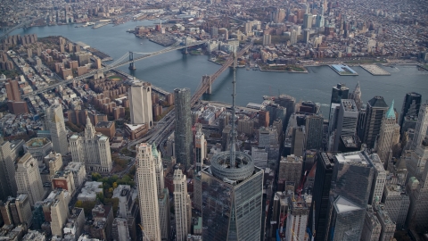 AX120_104.0000143F - Aerial stock photo of One World Trade Center spire, East River and bridges in Lower Manhattan, New York City