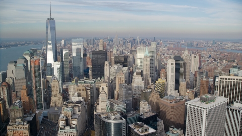 AX120_125.0000061F - Aerial stock photo of A view over the tops of Lower Manhattan skyscrapers, New York City