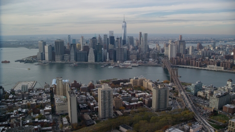 AX120_133.0000080F - Aerial stock photo of Lower Manhattan skyline and the East River seen from Brooklyn, New York City