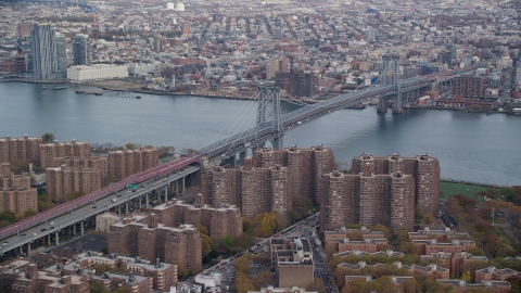 AX120_151.0000123F - Aerial stock photo of The Williamsburg Bridge and public housing in Autumn, New York City